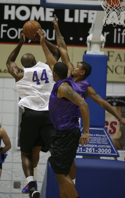 Rick Egan  | The Salt Lake Tribune 

Anthony Tolliver scores over Earl Watson, in the NBA lockout charity exhibition game at Lifetime Activities Center at Salt Lake Community College, Monday, November 7, 2011.