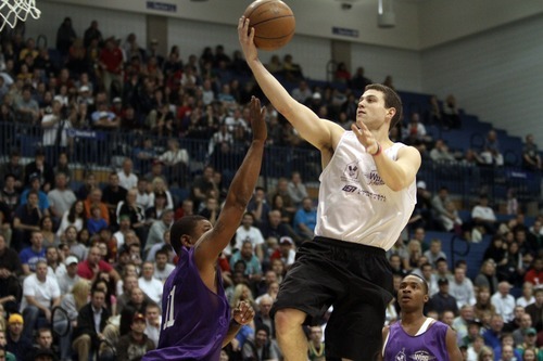 Rick Egan  | The Salt Lake Tribune 

Jimmer Fredette soars over Earl Watson for two, in the NBA lockout charity exhibition game at Lifetime Activities Center at Salt Lake Community College, Monday, November 7, 2011.