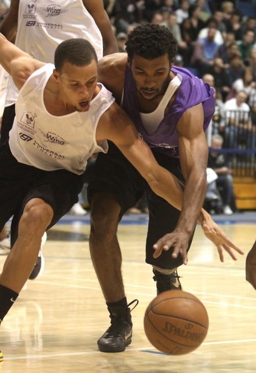 Rick Egan  | The Salt Lake Tribune 

Stephan Curry battles Ronnie Price for a loose ball, in the NBA lockout charity exhibition game at Lifetime Activities Center at Salt Lake Community College, Monday, November 7, 2011.