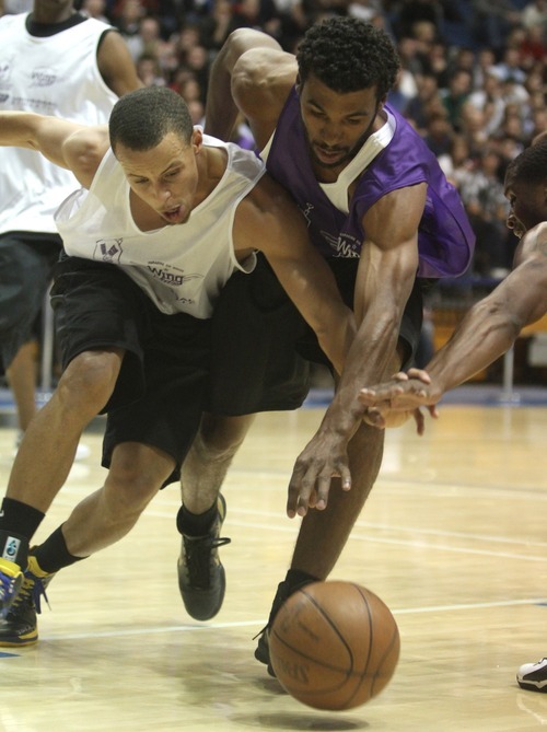 Rick Egan  | The Salt Lake Tribune 

Stephan Curry battles Ronnie Price for a loose ball, in the NBA lockout charity exhibition game at Lifetime Activities Center at Salt Lake Community College, Monday, November 7, 2011.