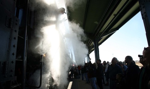 Leah Hogsten | The Salt Lake Tribune  
Onlookers quiz fireman Ted Schulte, who mans the 50,000-gallon water steam tender and 5,000-gallon working steam tank of Union Pacific's 844, a historic steam engine. The engine arrived Saturday at Ogden's Union Station. It will remain on display in Ogden on Sunday before moving on to Evanston, Wyo. The locomotive is the last steam locomotive built for Union Pacific Railroad in 1944 and was a high-speed passenger engine.