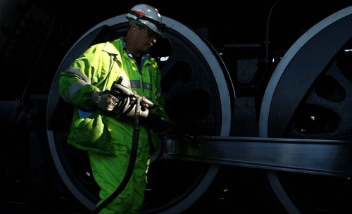 Leah Hogsten | The Salt Lake Tribune  
Union Pacific foreman Henry Krening of Cheyenne, Wyo., works on the massive wheels of Union Pacific's 844, a historic steam engine. The engine arrived Saturday at Ogden's Union Station. It will remain on display in Ogden on Sunday before moving on to Evanston, Wyo. The locomotive is the last steam locomotive built for Union Pacific Railroad in 1944 and was a high-speed passenger engine.