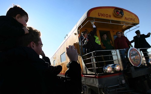 Leah Hogsten | The Salt Lake Tribune  
Chad Campbell, of Bountiful, and his 2-year-old son, Kellen, watch as Union Pacific's 844, a historic steam engine, arrives Saturday at Ogden's Union Station. It will remain on display on Sunday before moving on to Evanston, Wyo. The locomotive is the last steam locomotive built for Union Pacific Railroad in 1944 and was a high-speed passenger engine.