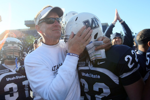 Chris Detrick  |  The Salt Lake Tribune
Utah State head coach Gary Andersen hugs Utah State Aggies tight end Keegan Andersen (22) after winning the game at Romney Stadium Saturday November 26, 2011. Utah State defeated Nevada 21-17 and will be bowl-eligible for the first time since 1997.