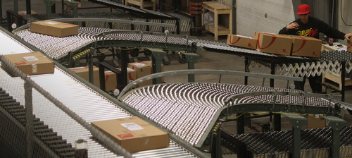 Rick Egan  | The Salt Lake Tribune 

Marissa Marones waits for packages to come down the rollers to load into the UPS truck at Overstock.com warehouse, on cyber Monday, November 28, 2011.