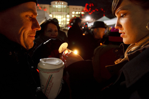 Trent Nelson  |  The Salt Lake Tribune
John O'Connor, left, and Paige Pitcher light candles at a gathering marking World Aids Day at the City & County Building in Salt Lake City, Utah, Thursday, December 1, 2011.