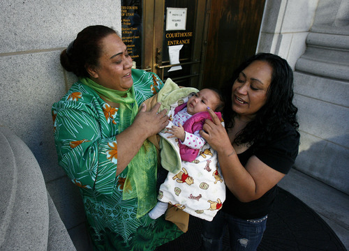 Scott Sommerdorf  |  The Salt Lake Tribune             
The family of Davey Kamoto, including his mother Mary, left, leaves the Frank E. Moss Federal Courthouse after U.S. District Court judge Tena Campbell ruled that he could be released from custody, Thursday, Dec. 1, 2011. At right is Sarah Ceron. Mary Kamoto holds her granddaughter, Cu Nessa.