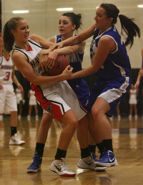 Kim Raff | The Salt Lake Tribune
Alta's player Makenzi Morrison wrestles for the ball with Fremont player s (left) Keely Swander and Codi Meibos during a girls basketball at Alta High School in East Sandy, Utah on Wednesday, November 30, 2011.   Alta went on to win the game.