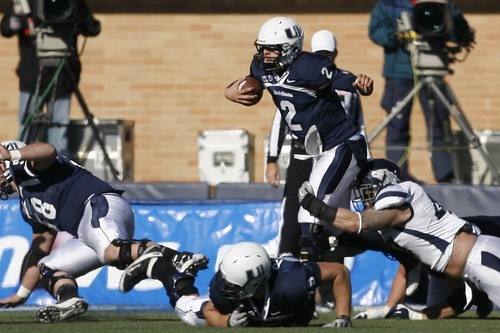Chris Detrick  |  The Salt Lake Tribune
Utah State Aggies quarterback Adam Kennedy (2) is tackled by Nevada Wolf Pack defensive lineman Brett Roy (47) during the first half of the game at Romney Stadium Saturday November 26, 2011. Nevada is winning the game 10-7.