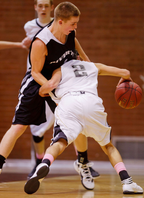 Trent Nelson  |  The Salt Lake Tribune
Highland's David Divver drives into Riverton's D McCleary at Highland vs. Riverton High School basketball in Salt Lake City, Utah, Friday, December 2, 2011.