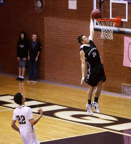 Trent Nelson  |  The Salt Lake Tribune
Riverton's Stephan Holm dunks the ball as Highland's Liam Thomas looks on, at Highland vs. Riverton High School basketball in Salt Lake City, Utah, Friday, December 2, 2011.