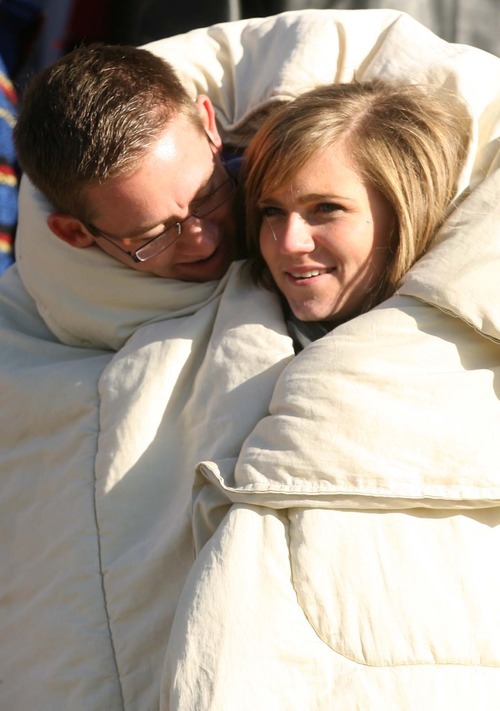 Leah Hogsten | The Salt Lake Tribune  
Snow College students Josh Burt and his girlfriend Hannah Olsen snuggle together in the freezing temperatures during football game at Rio Tinto Stadium. 
Snow College leads at the half 22-9 over Eastern Arizona  during the 8th Annual Top of the Mountain Bowl Saturday, December 3 2011