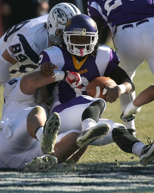 Leah Hogsten | The Salt Lake Tribune  
Eastern Arizona's Rashon Evans is brought down by Snow College's Matt Tanuvasa  (5) and Cody Van Buren (89). 
Snow College leads at the half 22-9 over Eastern Arizona  during the 8th Annual Top of the Mountain Bowl Saturday, December 3 2011