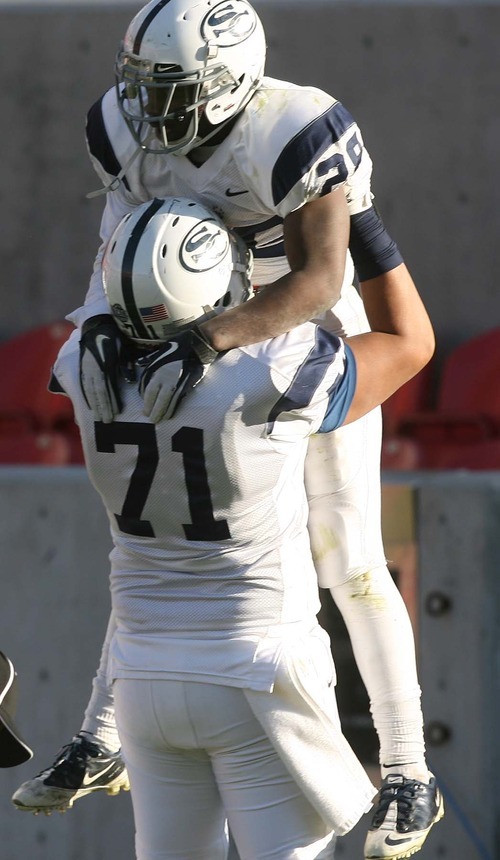 Leah Hogsten | The Salt Lake Tribune  
Snow's Breon Allen, congratulated by Justin Manu on his final scoring run,  made three touchdowns during the game.
Snow College defeated Eastern Arizona  36-9 during the 8th Annual Top of the Mountain Bowl Saturday, December 3 2011