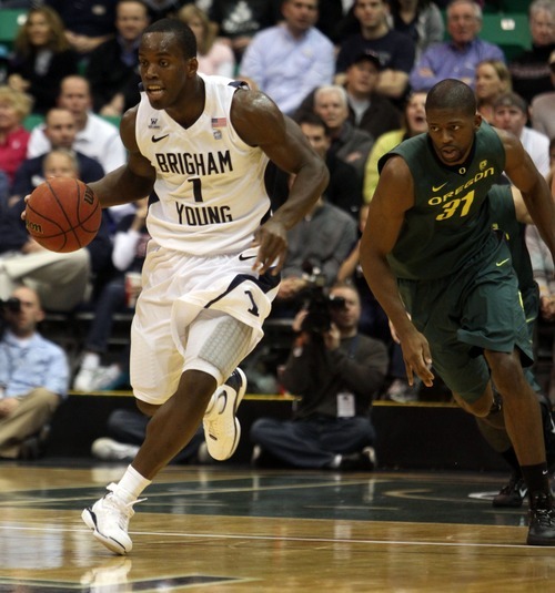 Rick Egan  | The Salt Lake Tribune 

BYU's Charles Abouo leads a fast break , as Tyrone Nared (31) trails behind for the Duck's in second half basketball action, BYU vs Oregon, at EnergySolutions Arena, Saturday, December 3, 2011.