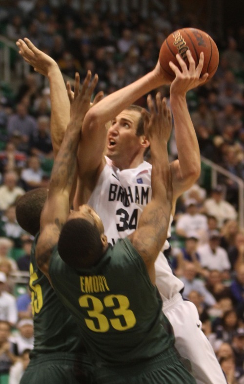 Rick Egan  | The Salt Lake Tribune 

BYU's Nate Hartsock goes up for a shot as Oregon's Tony Woods (55) and Carlos Emery (33) defend, in second half basketball action, BYU vs Oregon, at EnergySolutions Arena, Saturday, December 3, 2011.