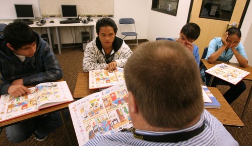 Leah Hogsten | The Salt Lake Tribune  
The four students in Brent Price's basic English class identify items in a book that Price calls out by name, Nov. 17, 2011, at Wasatch High School. KaPaw Htoo, 16, spends three class periods with Price and says he appreciates the one-on-one attention he gets.  
A Karen refugee, KaPaw Htoo spent his life in a Thai refugee camp before moving to Utah this summer with his parents, sister and three brothers. He started school at Cottonwood High in late August and transferred to Wasatch High School in November. He and his family do not speak English.