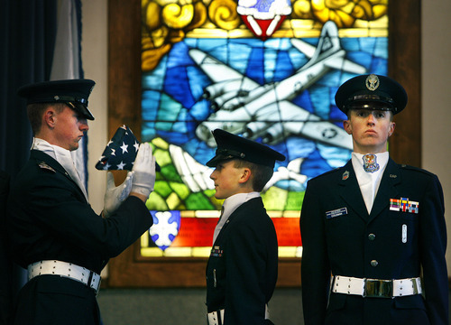 Scott Sommerdorf  |  The Salt Lake Tribune             
The Utah Wing Cadet Honor Guard performs a flag ceremony memorializing fallen comrades at the end of the ceremony on Sunday commemorating the 70th anniversary of the Civil Air Patrol at the Hill Aerospace Museum Chapel. Behind them is a stained glass depicting a WWII B-17 bomber of the 8th Air Force. Each December the patrol holds a memorial service to commemorate its establishment on Dec. 1, 1941. Retired Air Force Gen. Robert C. Oaks was the featured speaker.