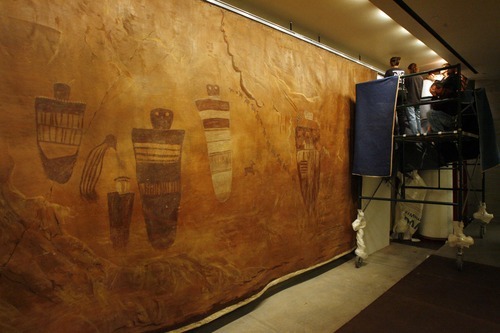 Rick Egan  | The Salt Lake Tribune 

Workers from Mage Wind Productions  hang a 60-foot-long Barrier Canyon mural in The Natural History Museum, Monday, Nov. 14, 2011.