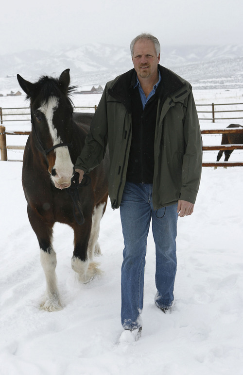 Former Jazz player and NBA record shot blocker Mark Eaton works with his horse 