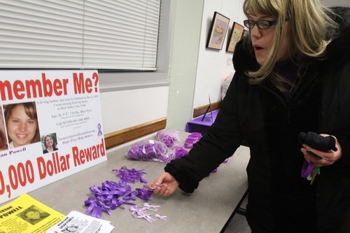 Rick Egan  | The Salt Lake Tribune 

Tina Bourgeois, of West Valley City,  grabs a purple ribbon after delivering her donation to the Christmas Box House on Monday. Friends and family of missing West Valley City woman Susan Cox Powell gathered donations for the Christmas Box House, at the Hunter Library in West Valley City.