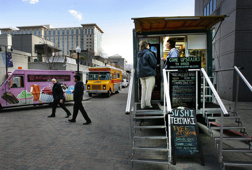 Scott Sommerdorf  |  The Salt Lake Tribune             
Food trucks from Cruzin Sushi, Chow Truck, SoCupcake, and Belli, and From Cakes to Crumbs sit at Gallivan Center Plaza, serving lunch, Thursday, December 1, 2011. Salt Lake City is looking to loosen rules on mobile food trucks to allow them to set up for 12-hour stints with a business and health dept. licenses. Right now, they are restricted to two hours and places like construction sites.