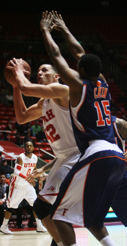 Kim Raff | The Salt Lake Tribune
Utah center Jason Washburn works on creating room while being defended by Cal State-Fullerton's Orane Chin at the Huntsman Center on Wednesday.
