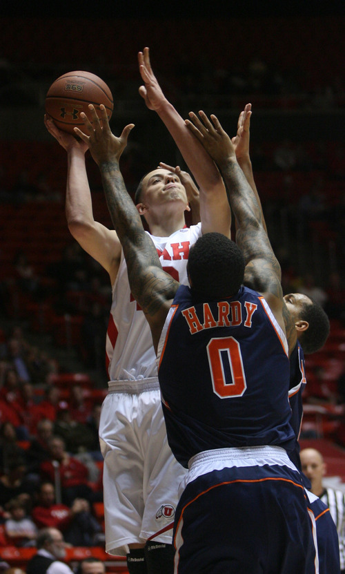 Kim Raff | The Salt Lake Tribune
Utah center Jason Washburn takes a shot while being guarded by Cal State-Fullerton's Andre Hardy at the Huntsman Center on Wednesday.