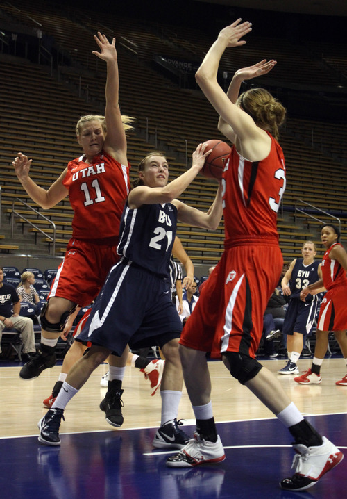 Rick Egan  | The Salt Lake Tribune 

Lexi Eaton (21) BYU, is double teamed by Taryn Wicijowski (11) and Diana Rolniak (32) of the Lady Ute's, at the Marriottt Center in Provo,   Saturday, December 10, 2011.