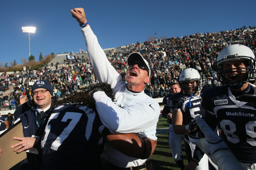 Chris Detrick  |  The Salt Lake Tribune
Utah State head coach Gary Andersen celebrates with Utah State Aggies defensive lineman Havea Lasike (57) after winning the game at Romney Stadium Saturday November 26, 2011. Utah State defeated Nevada 21-17 and will be bowl-eligible for the first time since 1997.