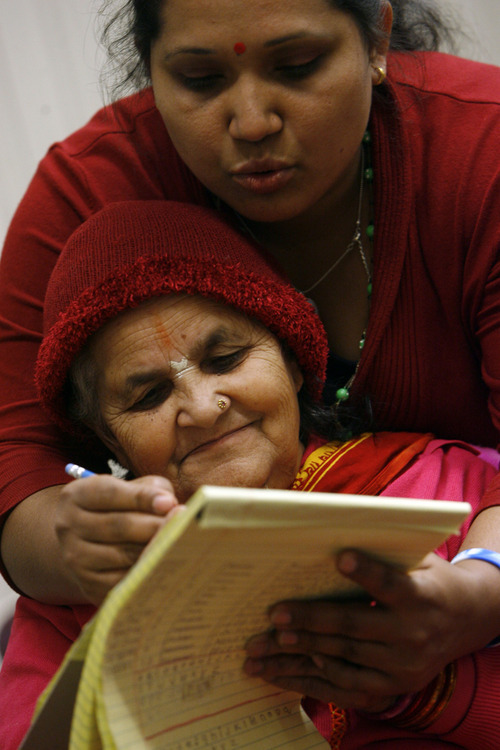 Francisco Kjolseth  |  The Salt Lake Tribune
English instructor Divya Acharya helps Ganga Baral spell out a sentence as Bhutanese refugees attend a weekly English and citizenship class at an LDS wardhouse in Salt Lake City on Saturday. Doctors have identified a B12 vitamin deficiency in newly arriving Bhutanese refugees due to their poor diet in refugee camps over decades. The vitamin deficiency can lead to neurologic disorders. Now doctors are trying to encourage the newcomers to take vitamins and eat better. This is a nationwide issue.