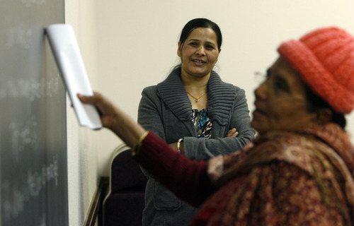 Francisco Kjolseth  |  The Salt Lake Tribune
Instructor Bhim Sapkota, center, helps a Bhutanese refugee read from the chalkboard during a weekly English and citizenship class on Saturday. Doctors have identified a B12 vitamin deficiency in newly arriving Bhutanese refugees due to their poor diet in refugee camps over decades. The vitamin deficiency can lead to neurologic disorders. Now doctors are trying to encourage the newcomers to take vitamins and eat better. This is a nationwide issue.