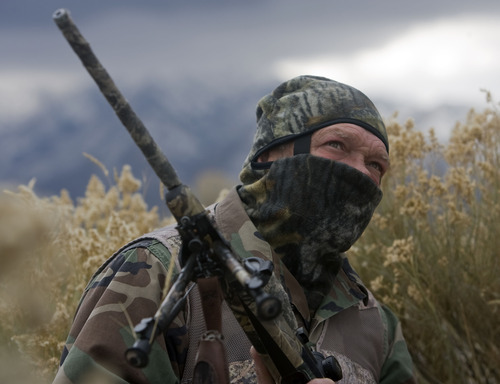 Al Hartmann  |  The Salt Lake Tribune
Bill Keebler waits in camoflague in the brush with a high view of an area and waits for coyote or uses one of his coyote calls to lure them in. His guide and outfitter service is headquartered in Tooele County.