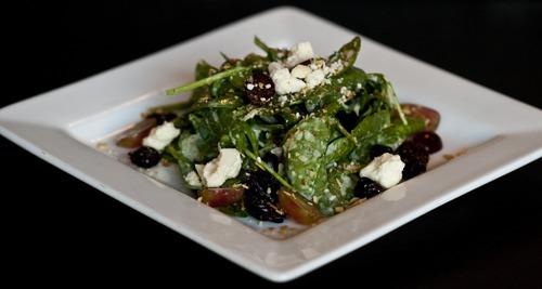 Chris Detrick  |  The Salt Lake Tribune
The Market Salad with spinach, dried cherries, feta, toasted almonds, grapes, at Pago Tuesday December 6, 2011. Pago builds its menu around the products it can buy locally, like beef, lamb, pork, produce, even the tequila it uses is locally made. Inside, products are sustainable too: It is making drinking glasses out of the wine bottles it uses; tables are reclaimed wood; countertops are from recycled paper.
