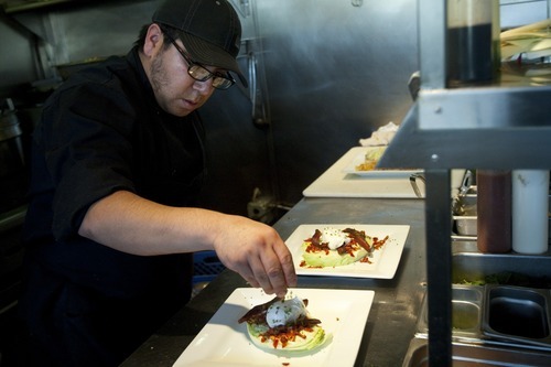 Chris Detrick  |  The Salt Lake Tribune
Benjamin Delgado prepares the Wedge Salad (iceberg lettuce, pancetta, poached farm egg, sun dried tomato aioli and chives $12) at Pago Tuesday December 6, 2011. Pago builds its menu around the products it can buy locally, like beef, lamb, pork, produce, even the tequila it uses is locally made. Inside, products are sustainable too: It is making drinking glasses out of the wine bottles it uses; tables are reclaimed wood; countertops are from recycled paper.