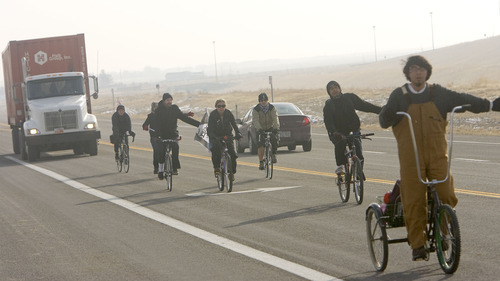 Al Hartmann  |  The Salt Lake Tribune
Members of OWS-Salt Lake staged a protest at the WalMart distribution center west of Granstville Monday December 12.  They slowly rode bikes in small groups along State Road 138 disrupting the flow of traffic in and out of the distribution center.