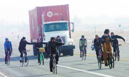 Al Hartmann  |  The Salt Lake Tribune
Members of OWS-Salt Lake staged a protest at the WalMart distribution center west of Granstville Monday December 12.  They slowly rode bikes in small groups along State Road 138 disrupting the flow of traffic in and out of the distribution center.