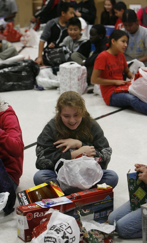 Francisco Kjolseth  |  The Salt Lake Tribune
Lincoln Elementary school student Jade Ficklin, 11, hugs her new football as she joins her sixth-grade classmates in the school gym to open presents on Thursday Lincoln Elementary School has one of the highest percentages of children  living below the poverty line. Without gifts from the Salt Lake Community and Utah Central Credit Union, these children would not have Christmas. Every child receives the gifts they have personally requested – a 