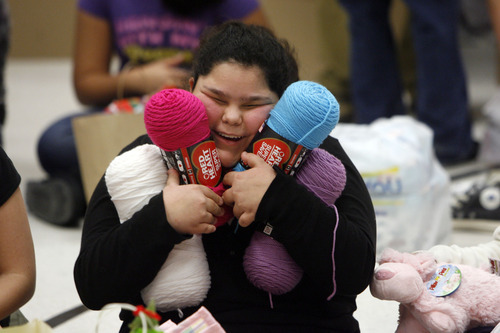 Francisco Kjolseth  |  The Salt Lake Tribune
Lincoln Elementary school 6th grader Trina James, 12, is overjoyed with the gift of yarn which she hopes to make into scarves and a hat for herself and her sister and grandma as she joins other classmates opening presents on Thursday, December 15, 2011. Lincoln Elementary School has one of the highest percentages of children – about 95% -- living below the poverty line. Without gifts from the Salt Lake Community and Utah Central Credit Union, these children would not have Christmas. Every child receives the gifts they have personally requested – a 