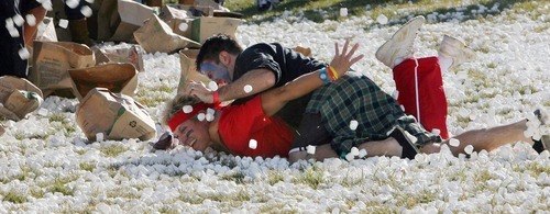 Steve Griffin  |  The Salt Lake Tribune
Eisenhower Junior High  teacher and team captain, Zach Layton,  tackles fellow teacher and opposing captain, Denise Fiack, on a marshmallow battlefield. Hundreds of students at Eisenhower Junior High attempted a new world record for the world's largest marshmallow fight by throwing 2,000 pounds of marshmallows -- about 140,000 of them -- in about 10 minutes. Following the battle students cleaned up the whole mess.