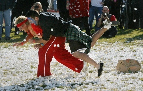 Steve Griffin  |  The Salt Lake Tribune
Eisenhower Junior High  teacher and team captain, Zach Layton,  tackles fellow teacher and opposing captain, Denise Fiack, on a marshmallow battlefield. Hundreds of students at Eisenhower Junior High attempted a new world record for the world's largest marshmallow fight by throwing 2,000 pounds of marshmallows -- about 140,000 of them -- in about 10 minutes. Following the battle students cleaned up the whole mess.