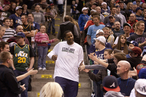 Jeremy Harmon  |  The Salt Lake Tribune

Utah's C.J. Miles greets fans in the stands prior to a scrimmage at EnergySolutions Arena in Salt Lake City, Saturday, Dec. 17, 2011.