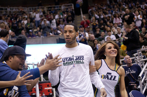 Jeremy Harmon  |  The Salt Lake Tribune

Utah's Devin Harris is escorted onto the court by one of the Jazz dancers prior to a scrimmage at EnergySolutions Arena in Salt Lake City, Saturday, Dec. 17, 2011.