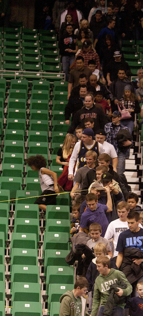 Jeremy Harmon  |  The Salt Lake Tribune

Fans pile into an empty section of seating at a Utah Jazz scrimmage at EnergySolutions Arena in Salt Lake City, Saturday, Dec. 17, 2011.