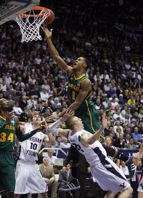 Steve Griffin  |  The Salt Lake Tribune

BYU's Nate AUstin draws a charging foul on Baylor's Perry Jones III during frist half action of the BYU Baylor basketball game  in Provo, Utah Saturday, December 17, 2011.