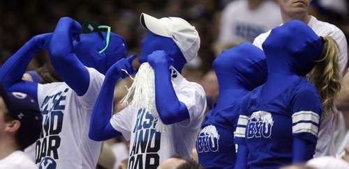 Steve Griffin  |  The Salt Lake Tribune

BYU fans dressed in blue body suits watch a play on the scoreboard during frist half action of the BYU Baylor basketball game  in Provo, Utah Saturday, December 17, 2011.