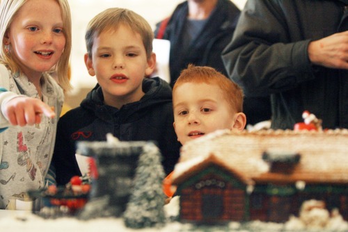 Kim Raff  I  The Salt Lake Tribune
Jaycee Driggs, left, Camden Driggs and Laden Munson look at the Villa Roma gingerbread house at the Holiday Gingerbread Festival on Saturday. More than 50 gingerbread houses were on display at Union Station at The Gateway in Salt Lake City. The festival is a fundraiser for the United Way of Salt Lake Neighborhood Centers.