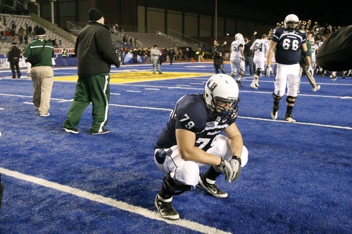 Chris Detrick  |  The Salt Lake Tribune
Utah State Aggies center Robert Hill (79) remains on the field after the Famous Idaho Potato Bowl at Bronco Stadium Saturday after last-minute 24-23 loss to Ohio.