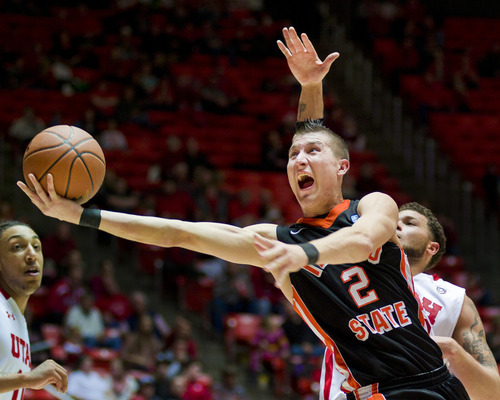 Idaho State Bengals guard Chase Grabau (2) shoots in front of Utah Utes Cedric Martin during the second half Friday, Dec. 16, 2011, in Salt Lake City, Utah. (© 2011 Douglas C. Pizac/Special to The Tribune)