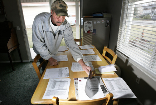 Scott Sommerdorf  |  The Salt Lake Tribune             
Gary Turley sorts through the many court and police documents he now keeps organized on his kitchen table in his West Bountiful home.